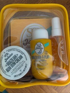 Sol de Janeiro travel set in bright yellow pouch w/ 2 extra mini’s